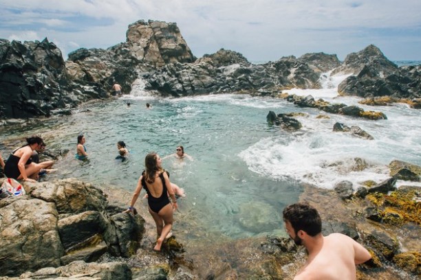 a group of people on a rocky beach